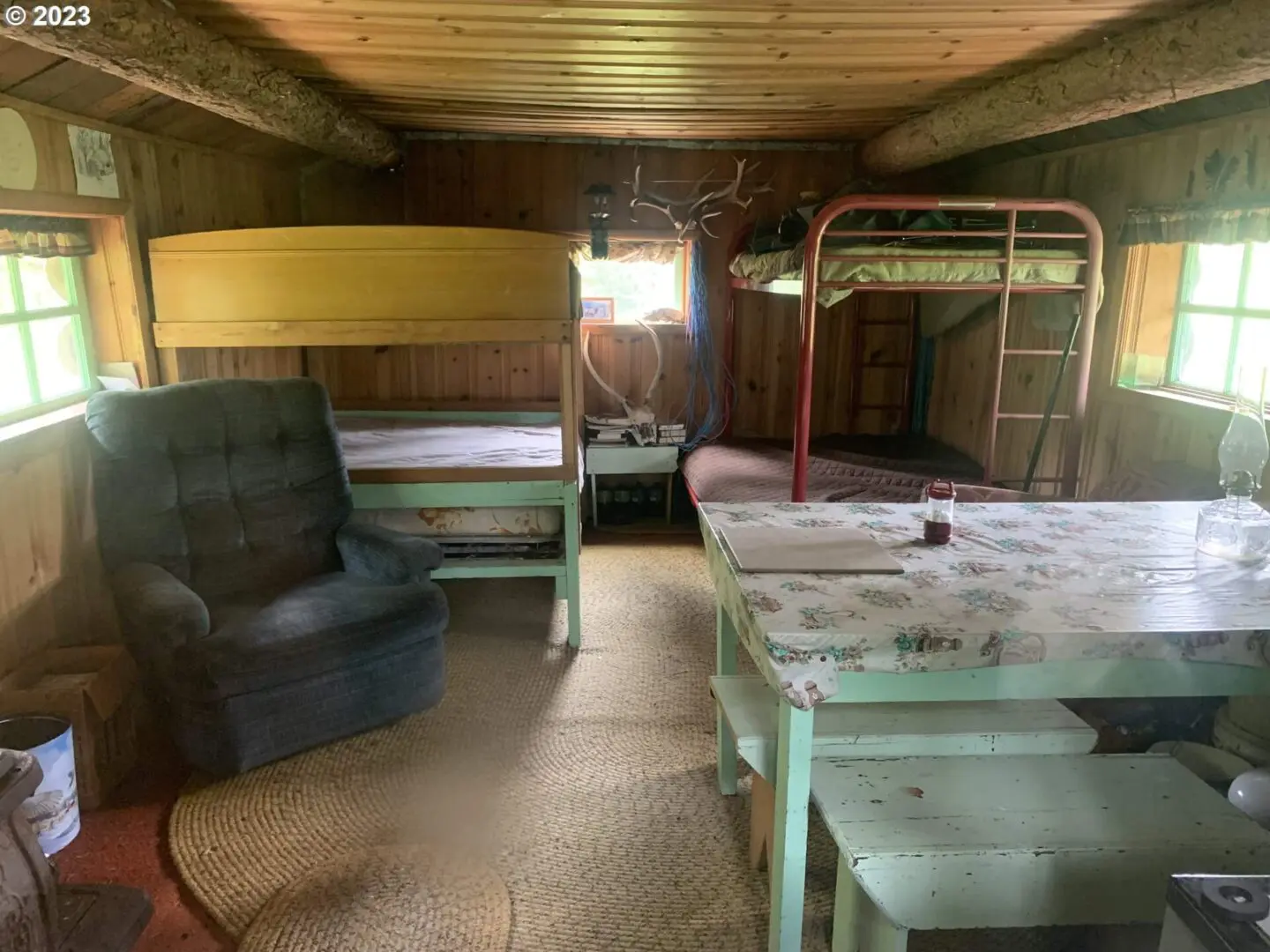 A room with bunk beds and a couch.