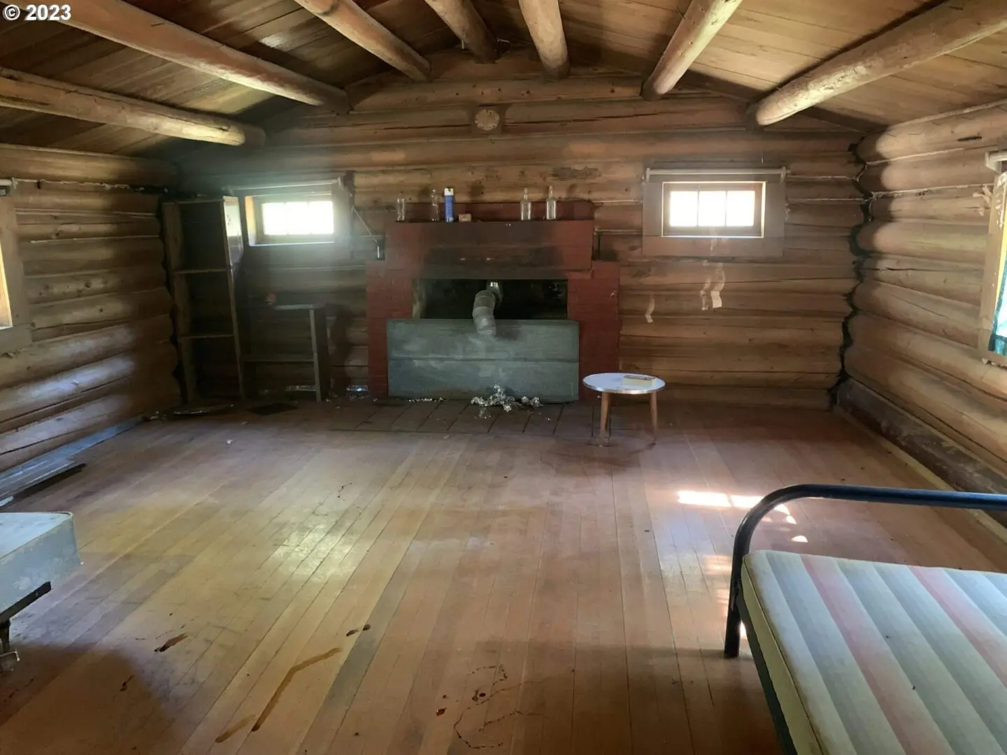 A room with wood floors and a fireplace.