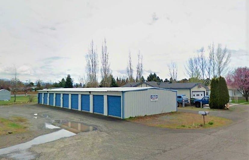 A large storage building with many doors and windows.