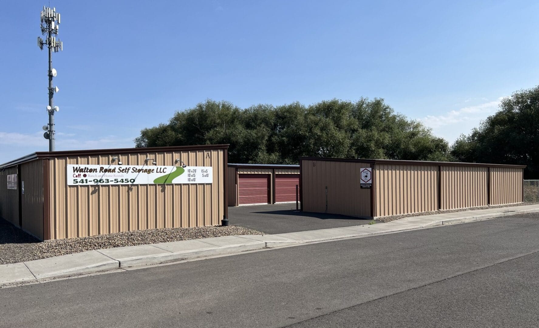 A large storage unit with a sign on the side of it.