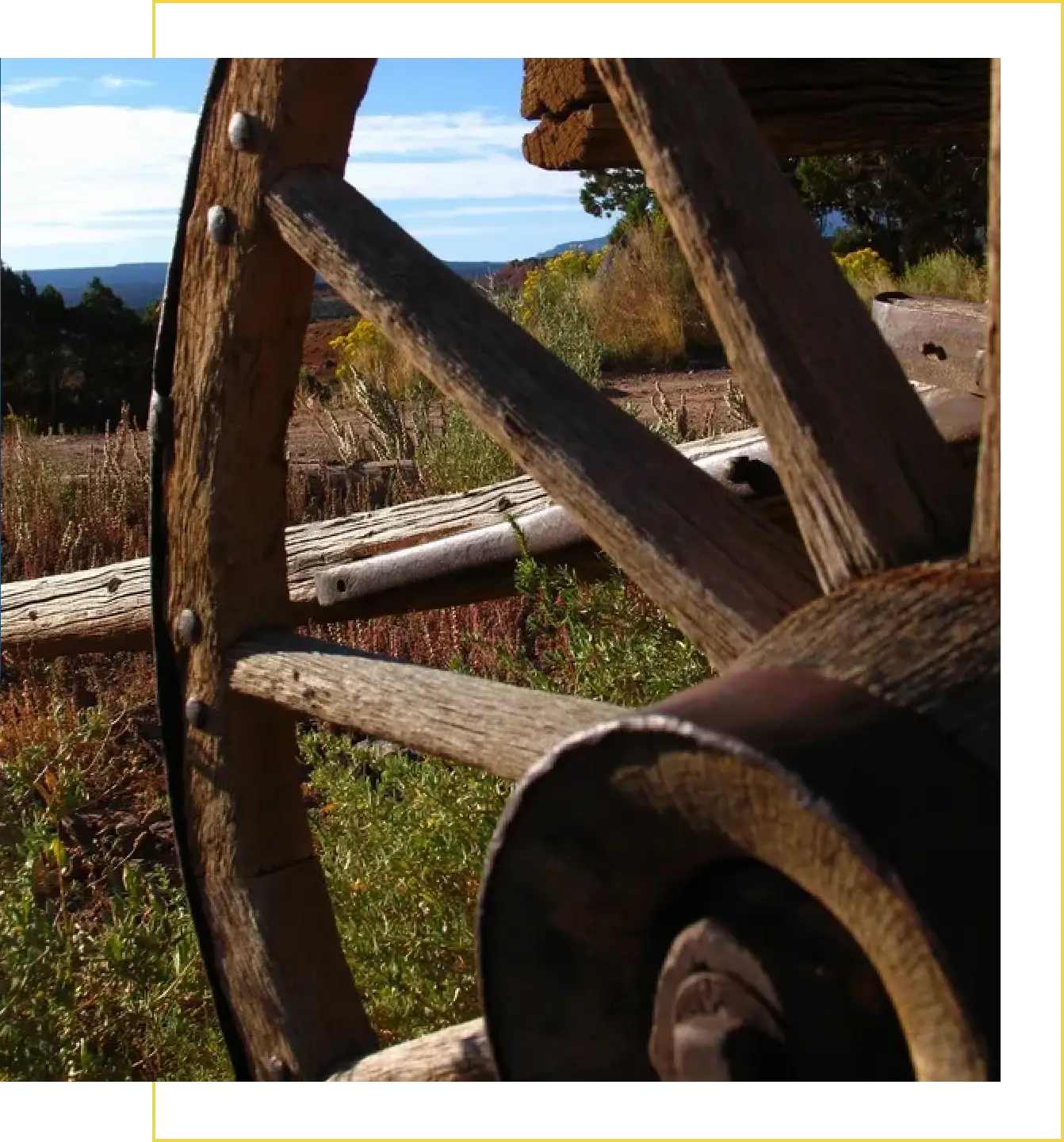 A close up of an old wooden wheel