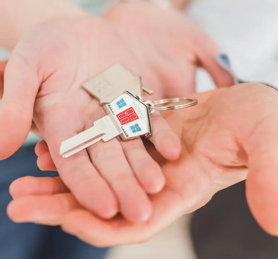 A person holding two keys in their hands.