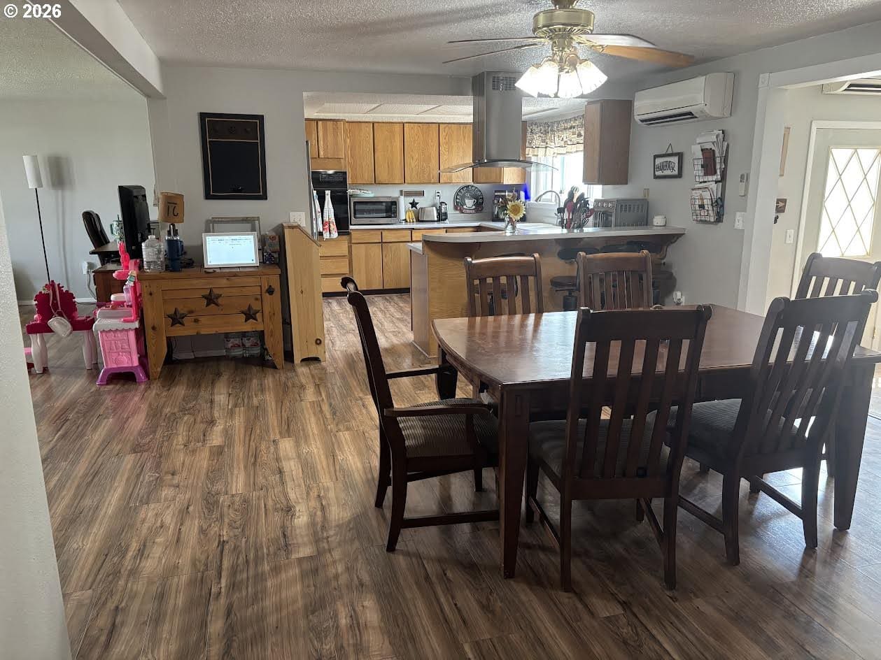 Open dining area with wooden furniture and decor.