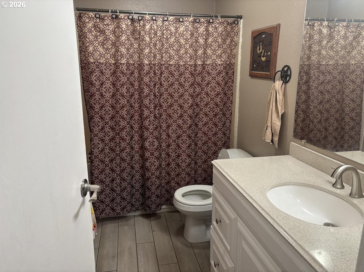 Bathroom with patterned shower curtain and sink.
