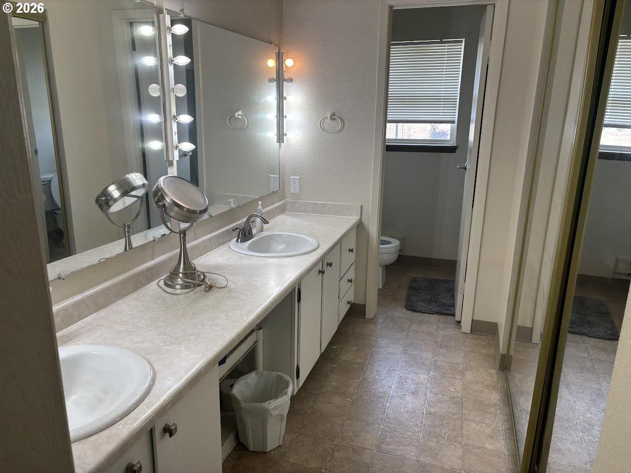 Bright bathroom with double sinks and mirrors.