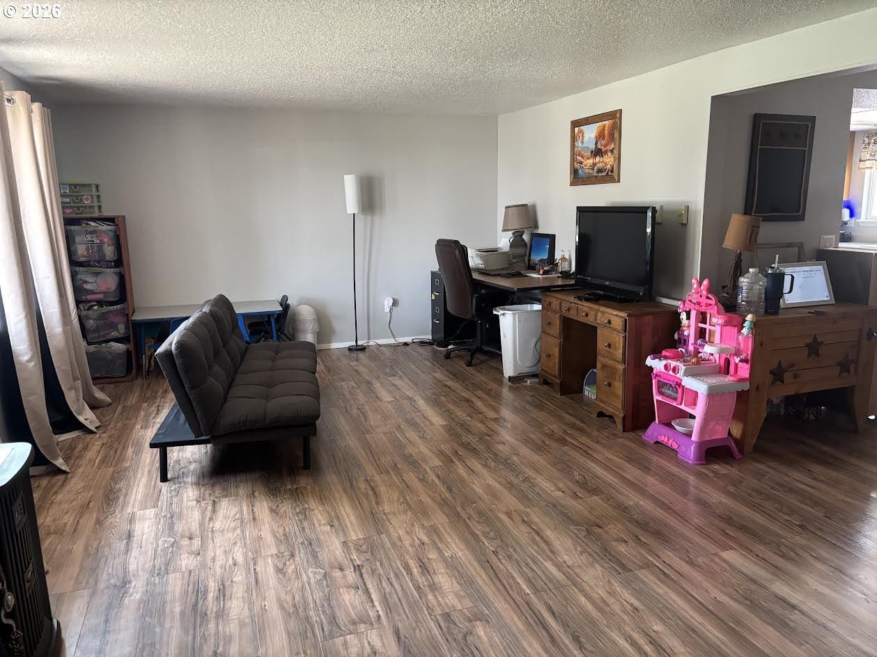 Cozy living room with wooden flooring and decor.