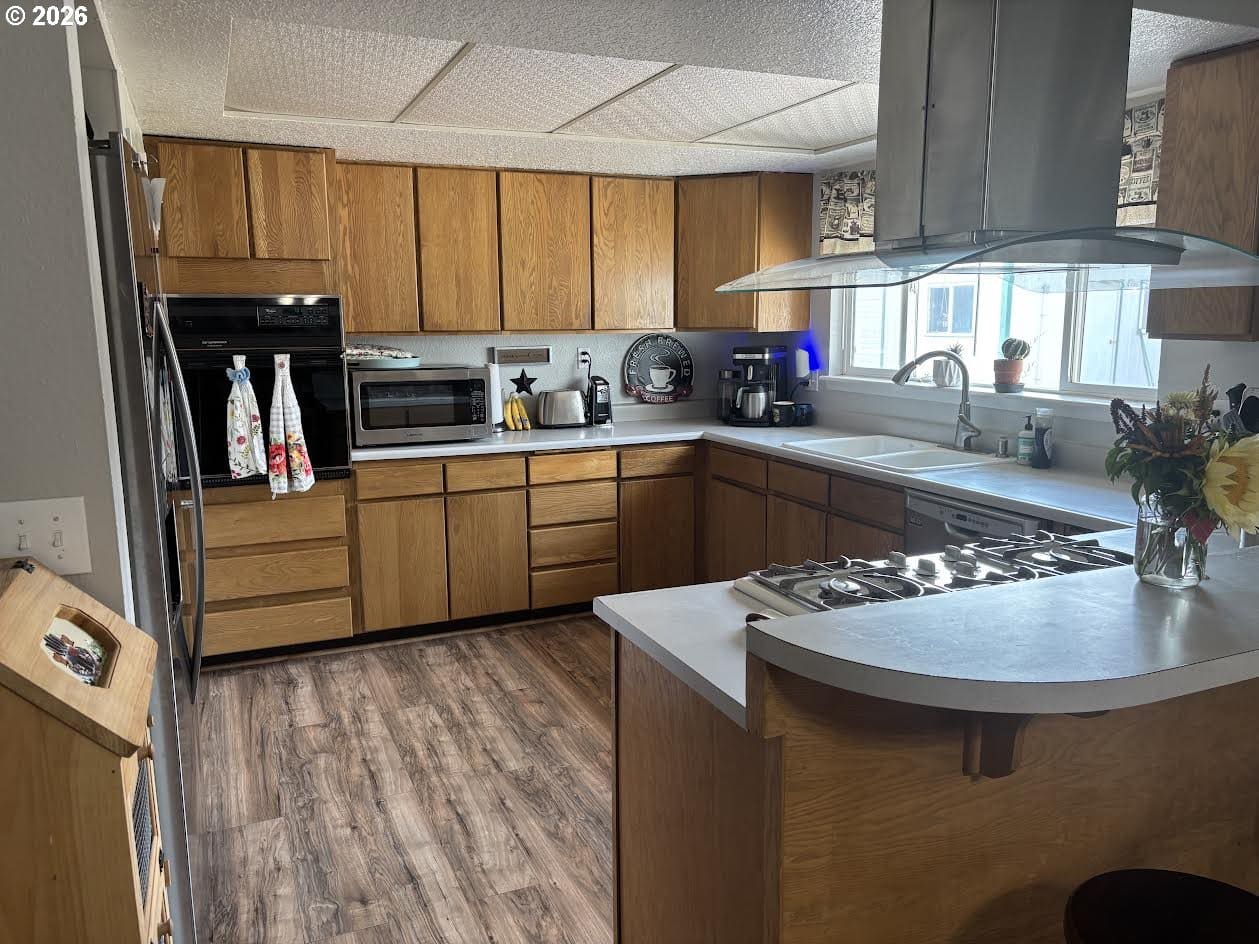Modern kitchen with wooden cabinets and appliances.