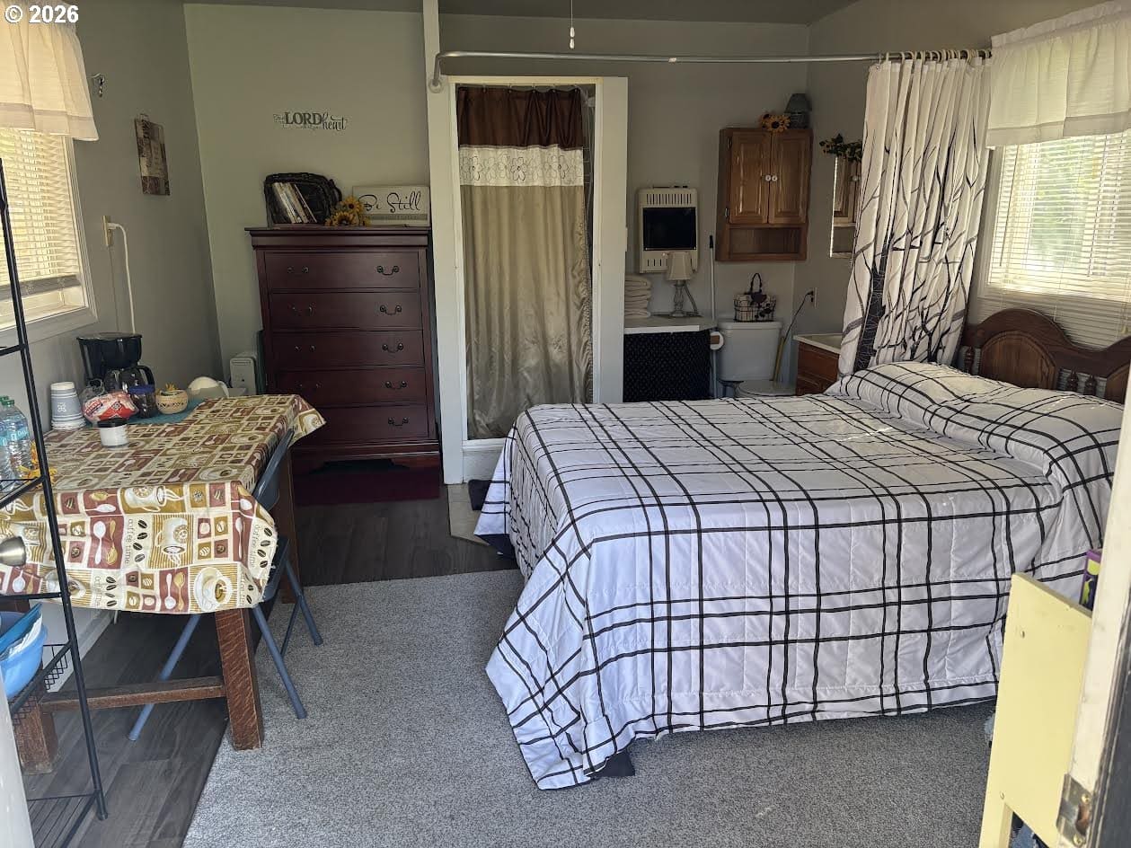 Cozy room with bed and dining table.