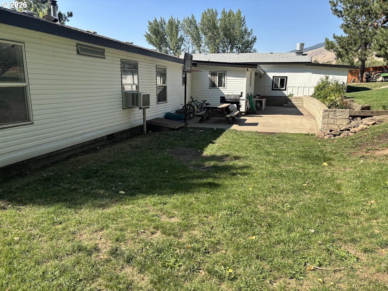 Side view of a house with grassy area.