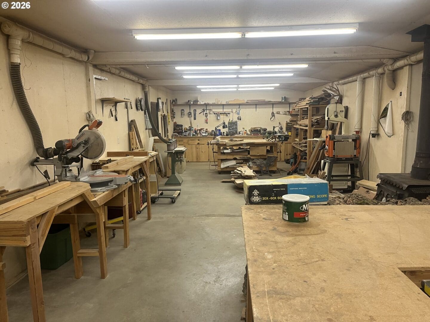 Woodworking shop with tools and workbenches.