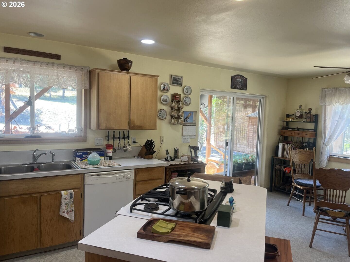 Cozy kitchen with wooden cabinets and natural light.